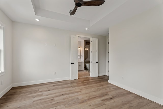 3224 Omega St, Houston, TX 77022 - unfurnished room with recessed lighting, light wood-style flooring, a ceiling fan, and a tray ceiling