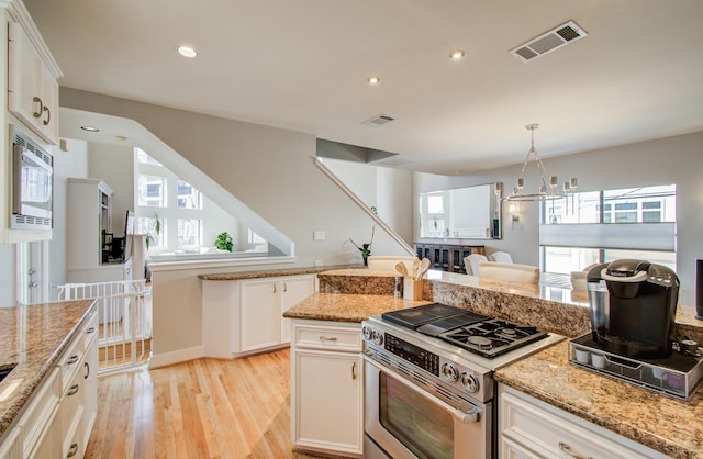 6205 Dell St, Houston, TX 77007 - kitchen with appliances with stainless steel finishes, light wood-type flooring, recessed lighting, light stone counters, and white cabinetry