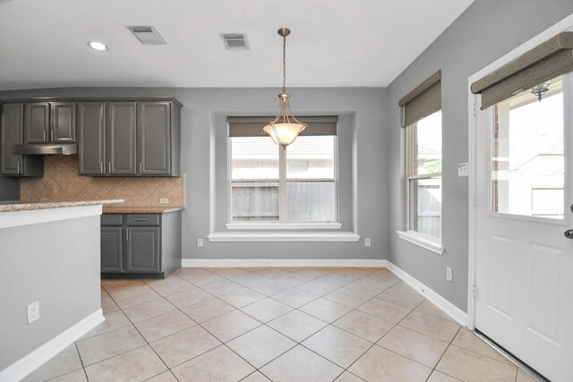 2923 Manchester Cv, Missouri City, TX 77459 - kitchen featuring tasteful backsplash, pendant lighting, light tile patterned flooring, and gray cabinets