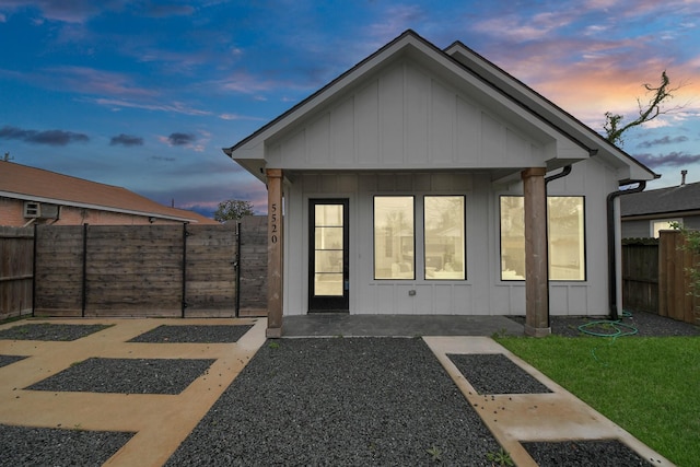 5520 Chapman St, Houston, TX 77009 - rear view of house with board and batten siding and a fenced backyard