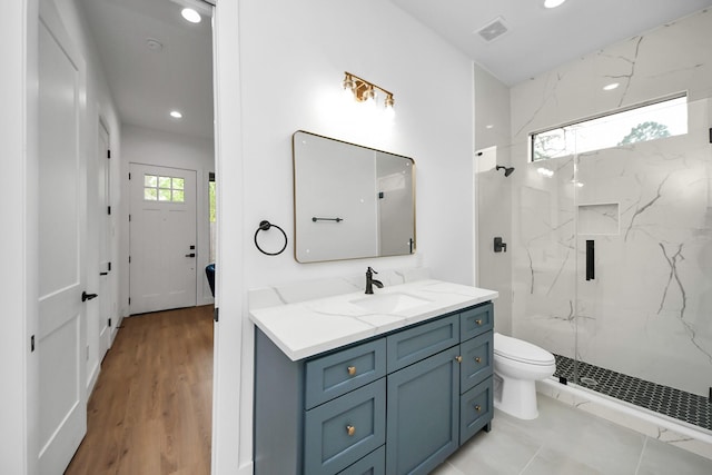 5520 Chapman St, Houston, TX 77009 - full bath featuring a marble finish shower, vanity, recessed lighting, and wood finished floors