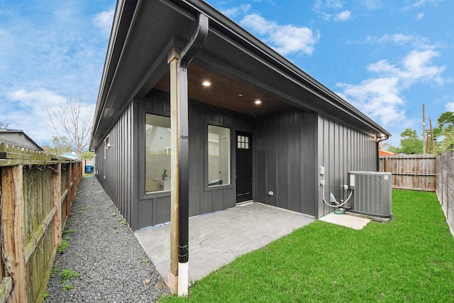 5520 Chapman St, Houston, TX 77009 - back of house with board and batten siding, a fenced backyard, and a patio
