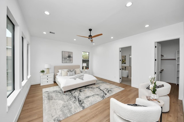 5520 Chapman St, Houston, TX 77009 - bedroom featuring light wood finished floors, a walk in closet, recessed lighting, connected bathroom, and a ceiling fan