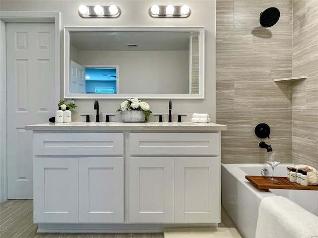 4815 Keeland St, Houston, TX 77016 - full bath with double vanity, shower / bathtub combination, and wood finished floors
