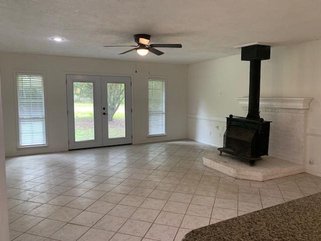 15025 Stagecoach Rd, Stagecoach, TX 77355 - unfurnished living room featuring light tile patterned floors, plenty of natural light, and a ceiling fan