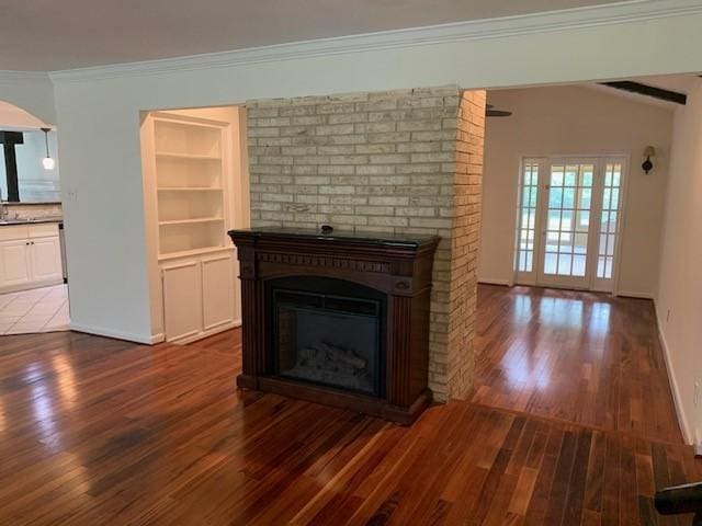 15025 Stagecoach Rd, Stagecoach, TX 77355 - unfurnished living room featuring dark wood-style flooring, a fireplace, and crown molding