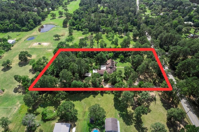 15025 Stagecoach Rd, Stagecoach, TX 77355 - aerial overview of property's location with a large body of water and property boundaries highlighted