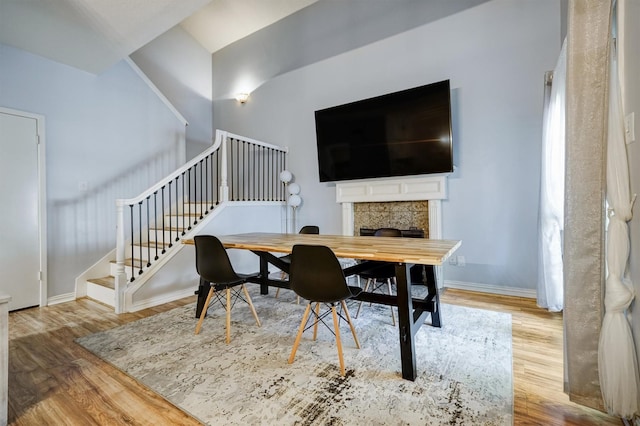 2601 Augusta Dr Unit 26, Houston, TX 77057 - dining space featuring stairs, wood finished floors, and a high end fireplace