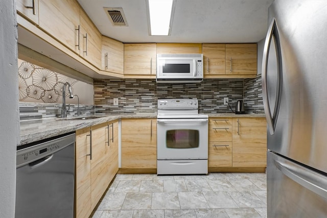 2601 Augusta Dr Unit 26, Houston, TX 77057 - kitchen with appliances with stainless steel finishes, tasteful backsplash, and light brown cabinets