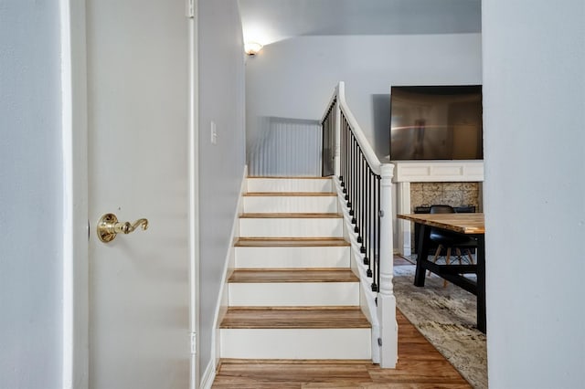 2601 Augusta Dr Unit 26, Houston, TX 77057 - staircase with wood finished floors and a fireplace