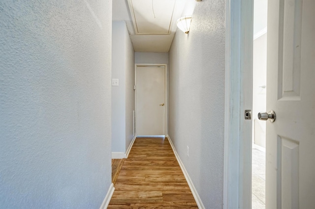 2601 Augusta Dr Unit 26, Houston, TX 77057 - hallway with a textured wall, wood finished floors, and attic access