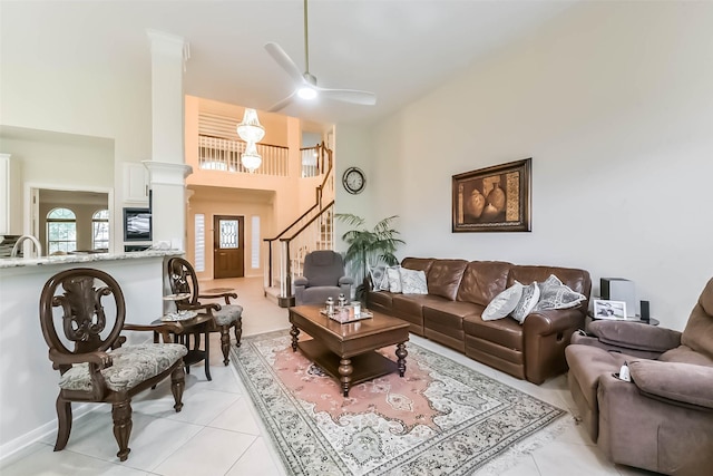 13719 Country Green Ct, Houston, TX 77059 - living room featuring light tile patterned flooring, ceiling fan, a high ceiling, and stairway