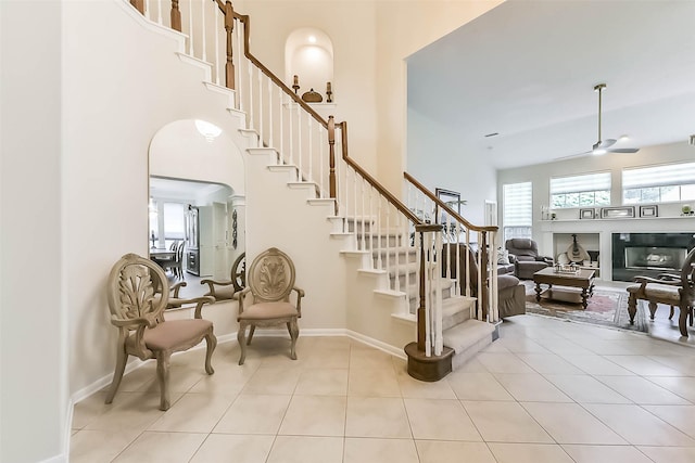 13719 Country Green Ct, Houston, TX 77059 - staircase featuring a towering ceiling, tile patterned floors, and arched walkways