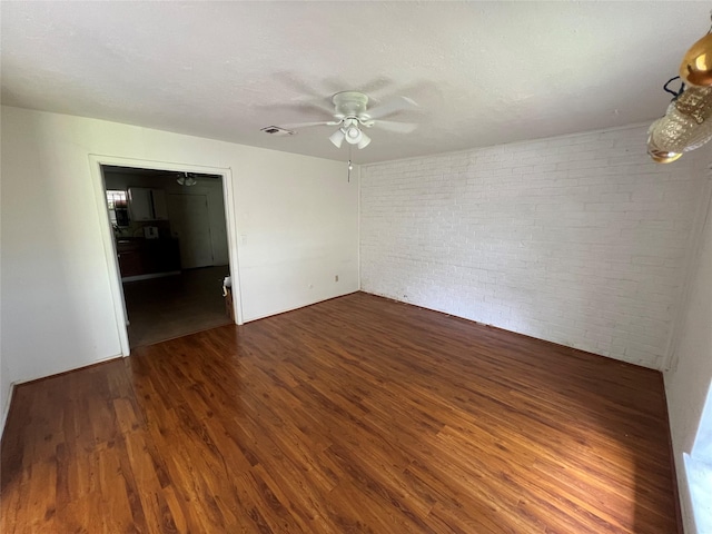 8330 Leamont Dr, Houston, TX 77072 - unfurnished room with wood finished floors, a ceiling fan, and brick wall