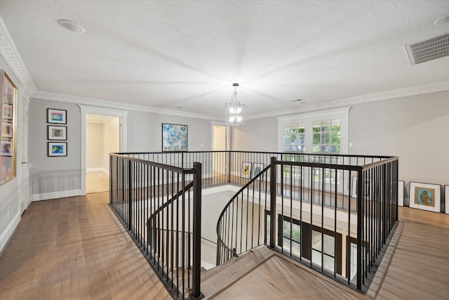 8703 Chelmsford Ln, Spring, TX 77379 - hall with an upstairs landing, a textured ceiling, crown molding, and wood finished floors