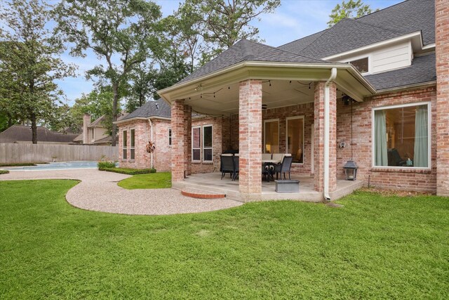 8703 Chelmsford Ln, Spring, TX 77379 - rear view of property with a patio, roof with shingles, and brick siding