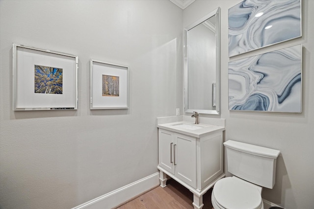 8703 Chelmsford Ln, Spring, TX 77379 - half bath with vanity, wood finished floors, and ornamental molding