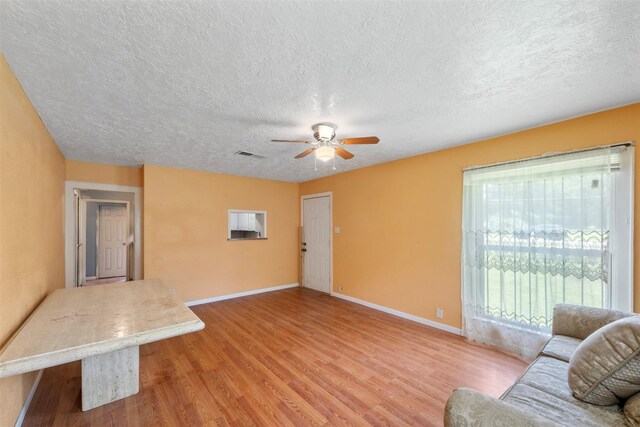 810 W N St, Livingston, TX 77351 - living area with a ceiling fan, a textured ceiling, and wood finished floors