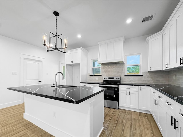 314 E Republic Ave, Baytown, TX 77520 - kitchen with electric range, dark countertops, recessed lighting, light wood finished floors, and a chandelier