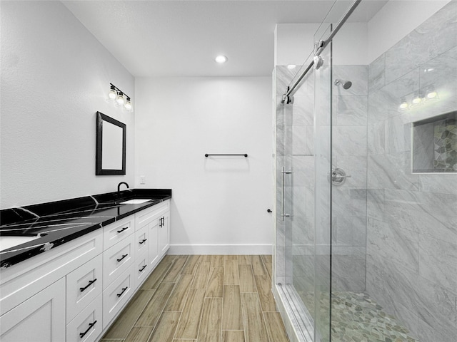 314 E Republic Ave, Baytown, TX 77520 - full bath with double vanity, a stall shower, wood finish floors, and recessed lighting