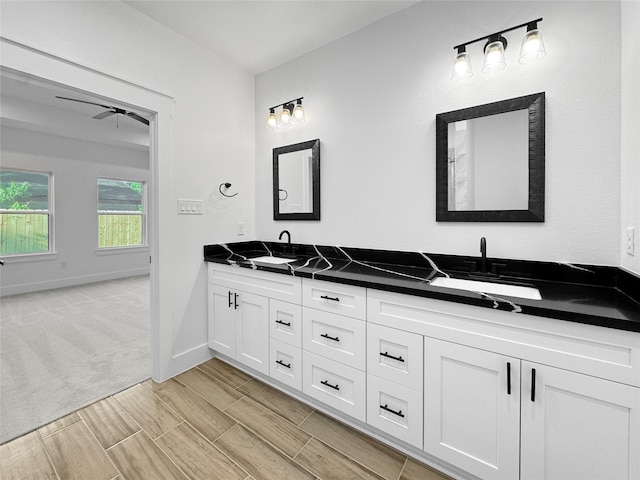 314 E Republic Ave, Baytown, TX 77520 - bathroom featuring double vanity, a ceiling fan, and wood tiled floors