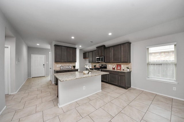 23714 Piedmont Forest Dr, Katy, TX 77493 - kitchen featuring stainless steel appliances, tasteful backsplash, dark brown cabinets, light stone countertops, and recessed lighting