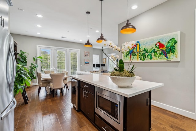 703 Bayou St, Houston, TX 77020 - kitchen featuring stainless steel appliances, dark brown cabinets, light countertops, pendant lighting, and recessed lighting