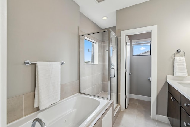 703 Bayou St, Houston, TX 77020 - full bath featuring a stall shower, a whirlpool tub, vanity, and tile patterned floors