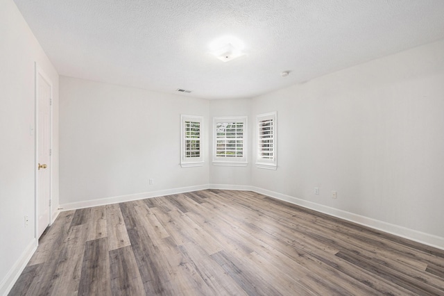 7921 Capri Cir, Houston, TX 77095 - spare room with wood finished floors and a textured ceiling