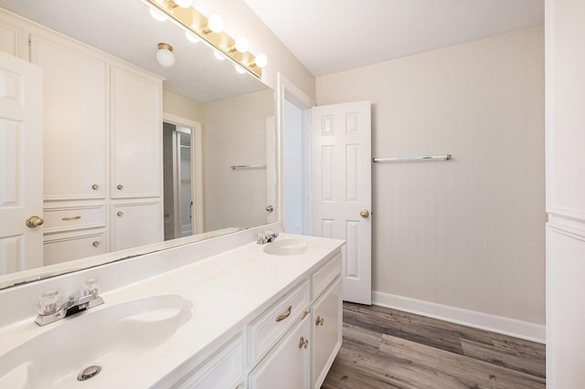 7921 Capri Cir, Houston, TX 77095 - bathroom featuring wood finished floors and double vanity