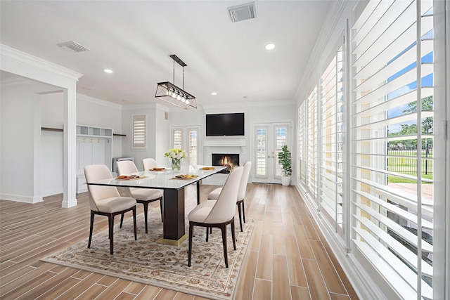 7921 Capri Cir, Houston, TX 77095 - dining area with wood finished floors, recessed lighting, a warm lit fireplace, and crown molding