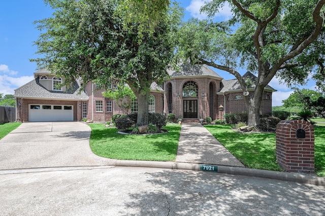 7921 Capri Cir, Houston, TX 77095 - view of front of house with brick siding, a front yard, driveway, an attached garage, and a shingled roof