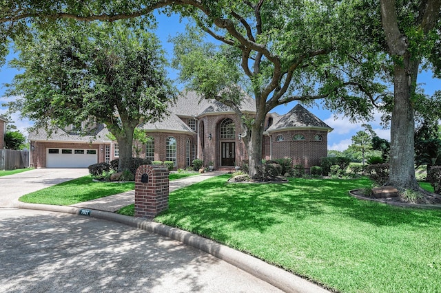 7921 Capri Cir, Houston, TX 77095 - view of front of home with brick siding, a front lawn, driveway, and a garage