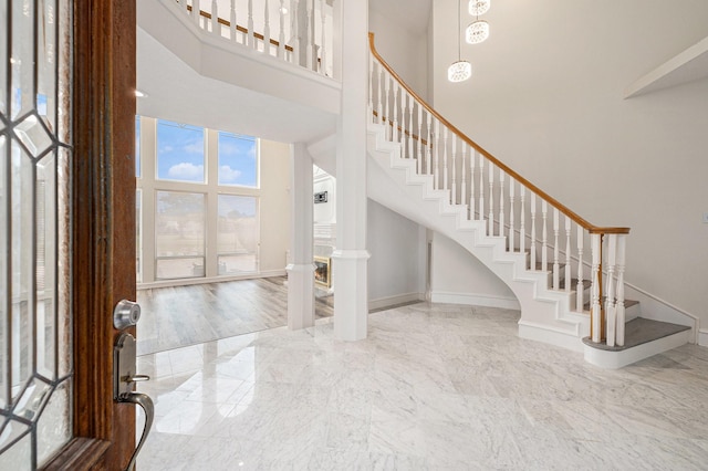 7921 Capri Cir, Houston, TX 77095 - foyer featuring a towering ceiling, stairway, and marble tiled flooring