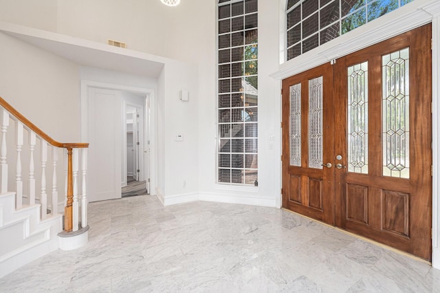 7921 Capri Cir, Houston, TX 77095 - entryway with stairs, a high ceiling, marble tiled floors, and french doors