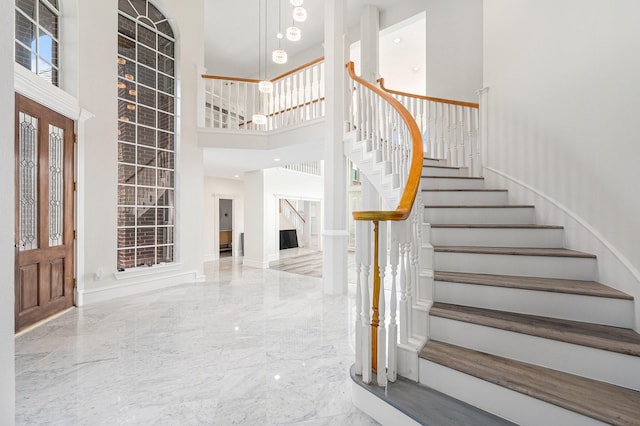 7921 Capri Cir, Houston, TX 77095 - foyer entrance featuring stairs, a towering ceiling, and marble tiled flooring
