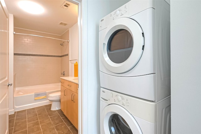 5925 Almeda Rd Unit 11608, Houston, TX 77004 - laundry area featuring stacked washer / drying machine and dark tile patterned flooring