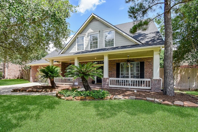 14023 Armant Place Dr, Cypress, TX 77429 - view of front of property featuring covered porch, brick siding, roof with shingles, and a ceiling fan