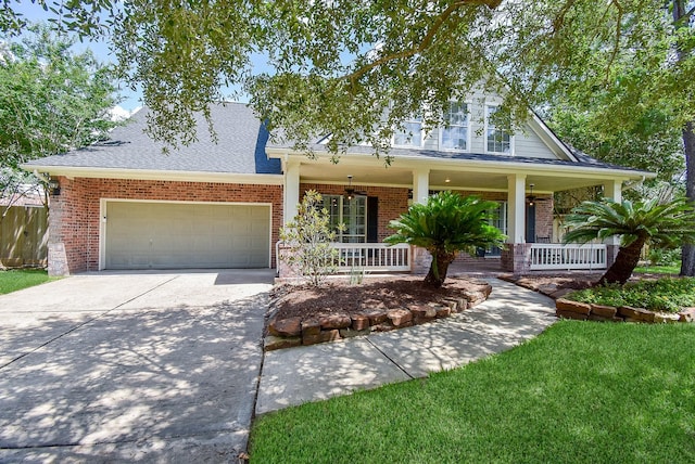 14023 Armant Place Dr, Cypress, TX 77429 - view of front of home featuring covered porch, brick siding, driveway, a garage, and roof with shingles