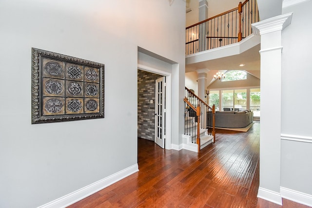 14023 Armant Place Dr, Cypress, TX 77429 - entryway featuring ornate columns, hardwood / wood-style flooring, stairs, and a towering ceiling