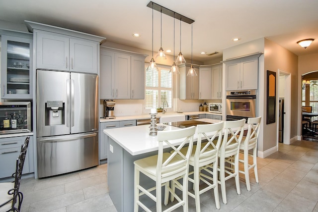 14023 Armant Place Dr, Cypress, TX 77429 - kitchen featuring appliances with stainless steel finishes, gray cabinetry, light tile patterned floors, light countertops, and recessed lighting