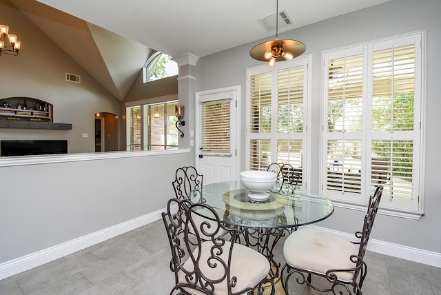 14023 Armant Place Dr, Cypress, TX 77429 - dining area featuring vaulted ceiling, arched walkways, tile patterned flooring, and a chandelier