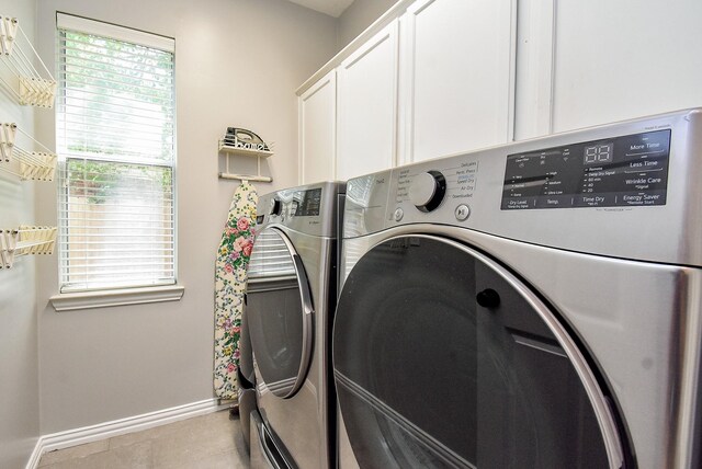 14023 Armant Place Dr, Cypress, TX 77429 - laundry room with cabinet space, washing machine and clothes dryer, and light tile patterned floors