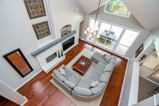 14023 Armant Place Dr, Cypress, TX 77429 - living area featuring a fireplace, high vaulted ceiling, hardwood / wood-style floors, and arched walkways