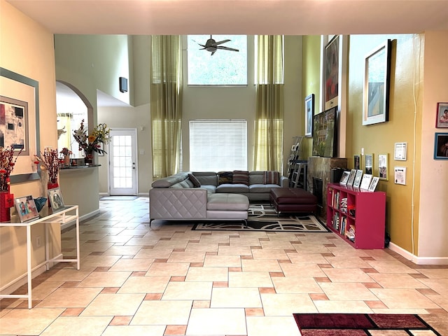 13518 Oak Bend Forest Dr, Houston, TX 77083 - living room featuring ceiling fan, arched walkways, and a towering ceiling