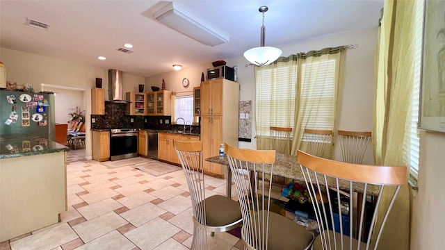 13518 Oak Bend Forest Dr, Houston, TX 77083 - kitchen featuring stainless steel appliances, wall chimney exhaust hood, backsplash, light brown cabinets, and pendant lighting