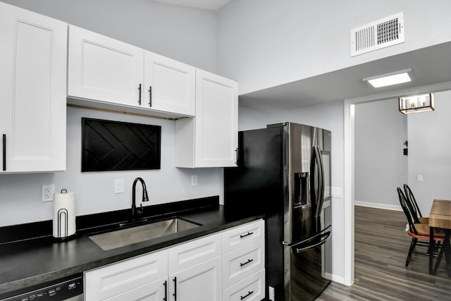 9809 Richmond Ave Unit B13, Houston, TX 77042 - kitchen featuring dark wood-style floors, refrigerator with ice dispenser, white cabinets, and dark countertops