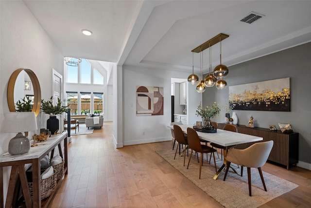18427 Counce Meadow Ct, Cypress, TX 77433 - dining room featuring light wood-type flooring and a raised ceiling