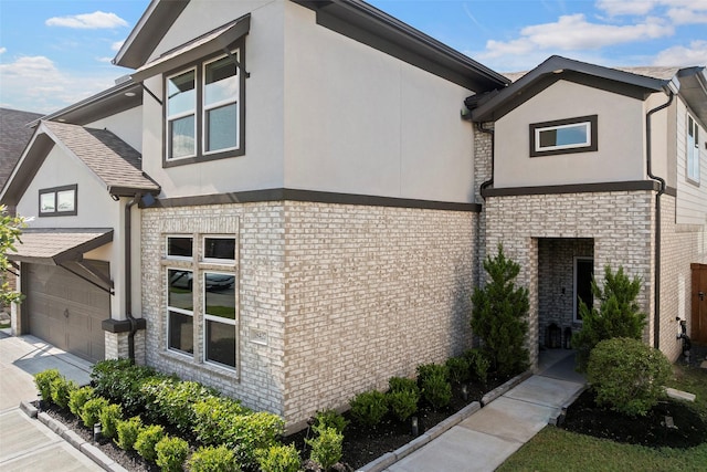 18427 Counce Meadow Ct, Cypress, TX 77433 - view of home's exterior with stucco siding, brick siding, an attached garage, and concrete driveway
