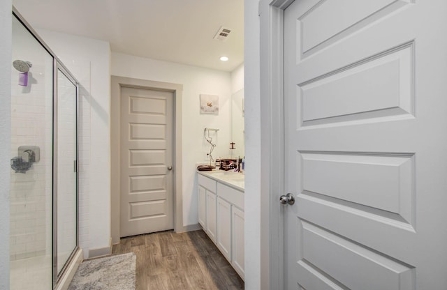 623 Hidden Brook Dr, Baytown, TX 77523 - bathroom featuring a stall shower, wood finished floors, vanity, and recessed lighting